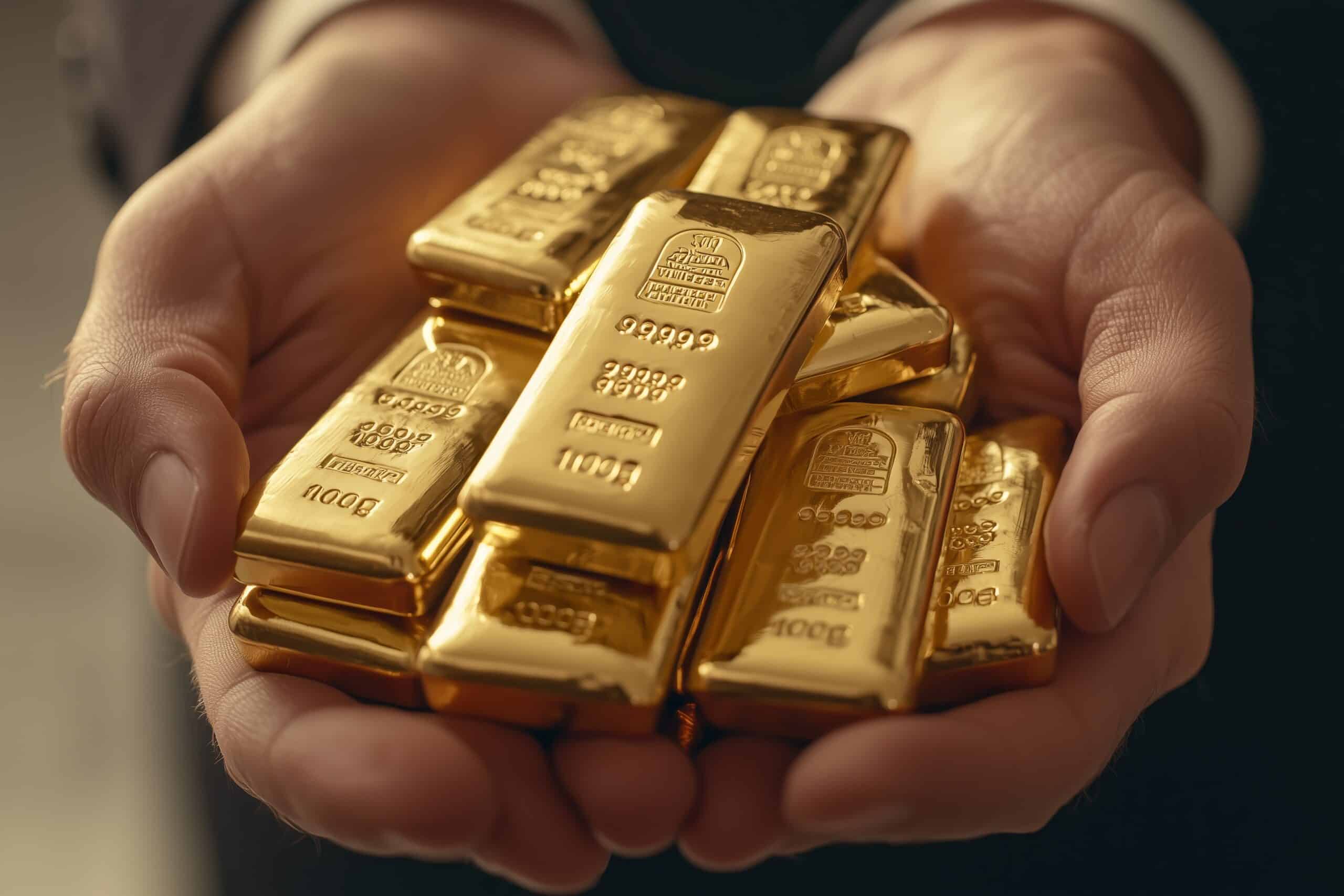 A close-up of hands holding multiple small gold bars, symbolizing wealth, finance and gold investment.